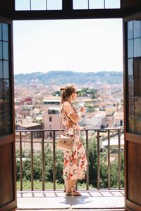 Woman standing on balcony at home