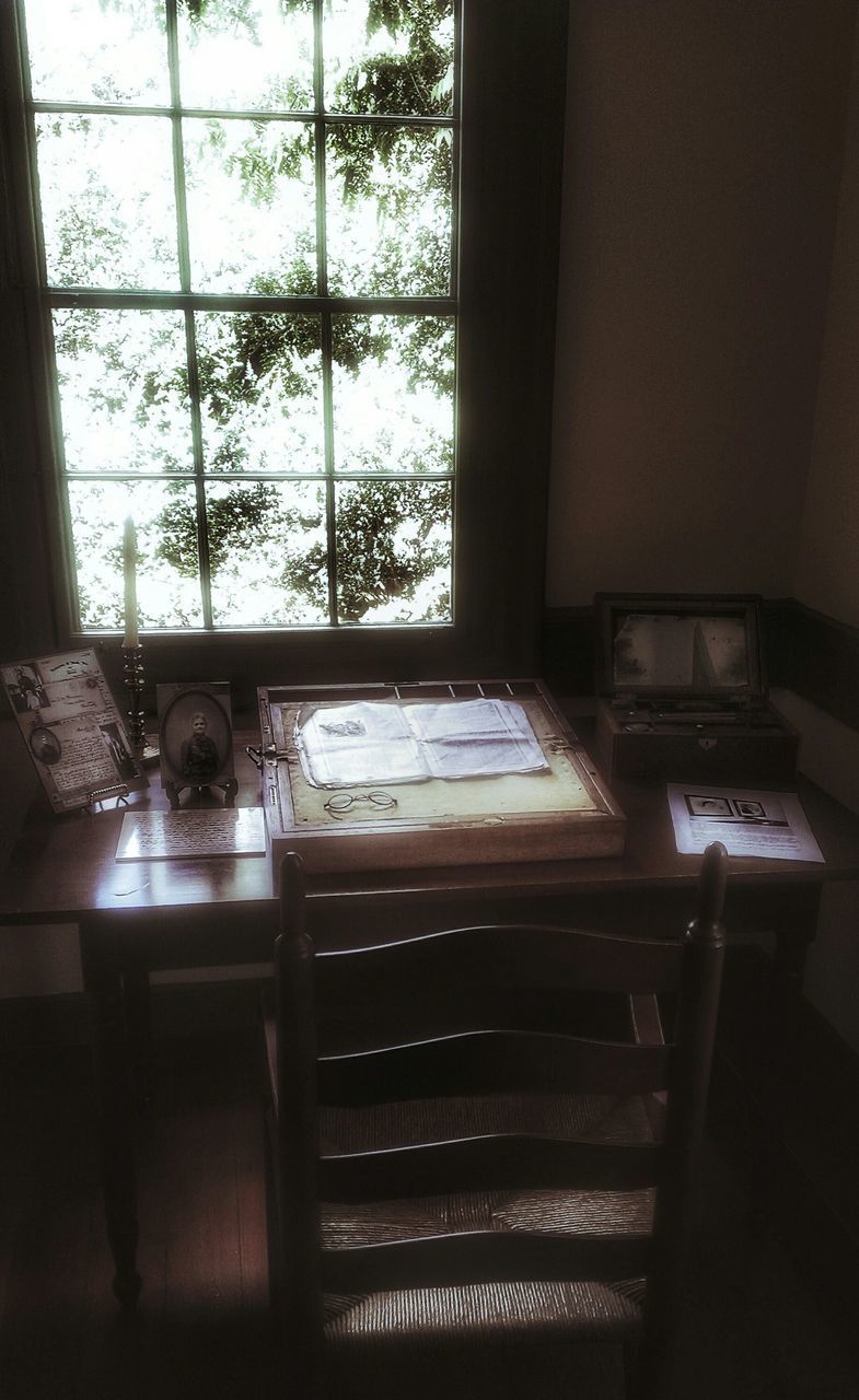 OPEN BOOK ON TABLE BY WINDOW