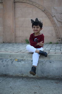 Portrait of boy sitting outdoors