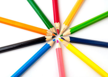 Close-up of colored pencils against white background