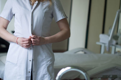 Midsection of nurse standing in hospital