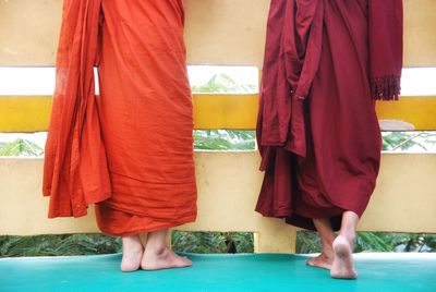 Low section of monks standing at temple