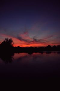 Scenic view of silhouette trees against sky at sunset