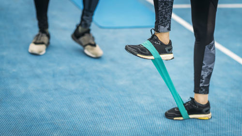 Low section of woman exercising with resistance band