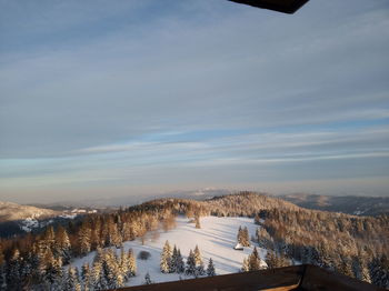 Scenic view of snow covered mountains against sky