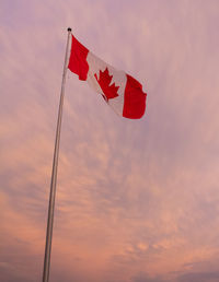 Low angle view of flag on pole against sky