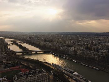 High angle view of seine river amidst cityscape against sky during sunset