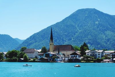 Boats in sea against buildings