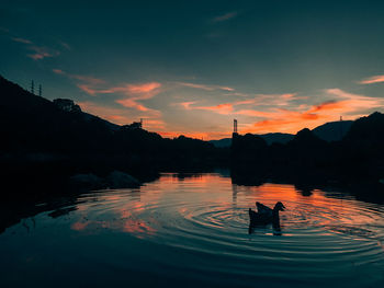 Scenic shot of calm lake at sunset