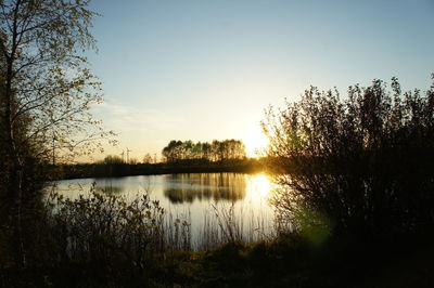 Scenic view of lake against sky during sunset