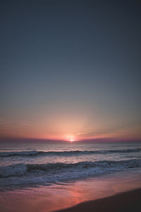 Scenic view of beach against sky during sunset