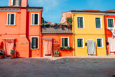 Houses by street against buildings in city