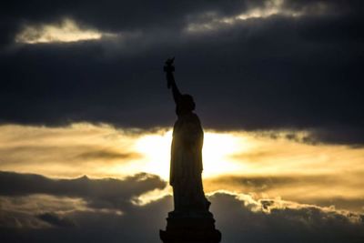 Low angle view of statue against cloudy sky