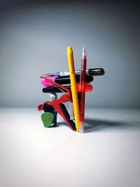 Close-up of multi colored pencils on table against white background