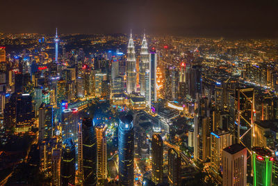 High angle view of illuminated city buildings at night