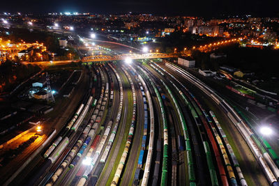 High angle view of trains at illuminated shunting yard at night