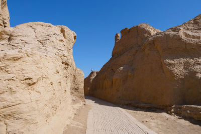 Panoramic view of rock formation against clear blue sky