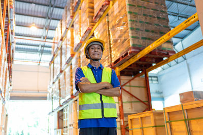 Low angle view of man working on building