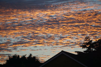 Low angle view of house against cloudy sky