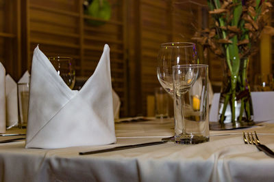 Drinking glass on table in restaurant