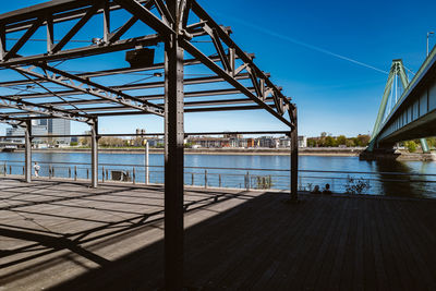 Bridge over sea against clear blue sky