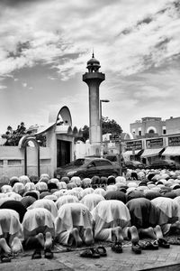 People in temple against sky in city