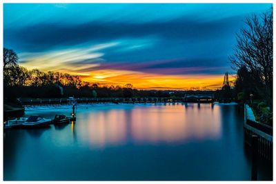 Scenic view of lake against sky at sunset