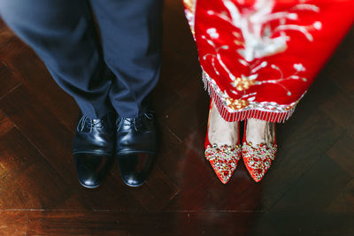 Low section of woman standing on hardwood floor