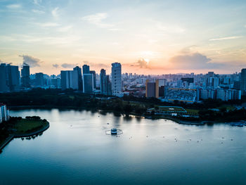 View of city at waterfront during sunset