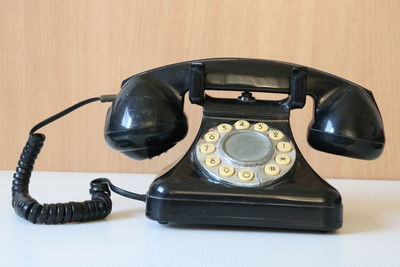 Close-up of telephone on table