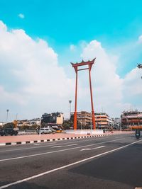 Road by street against sky in city