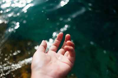 Close-up of hand over water