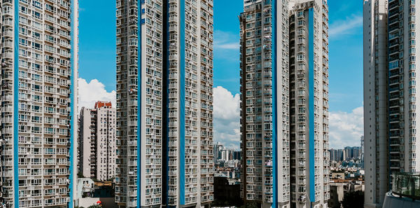 Low angle view of modern buildings against blue sky