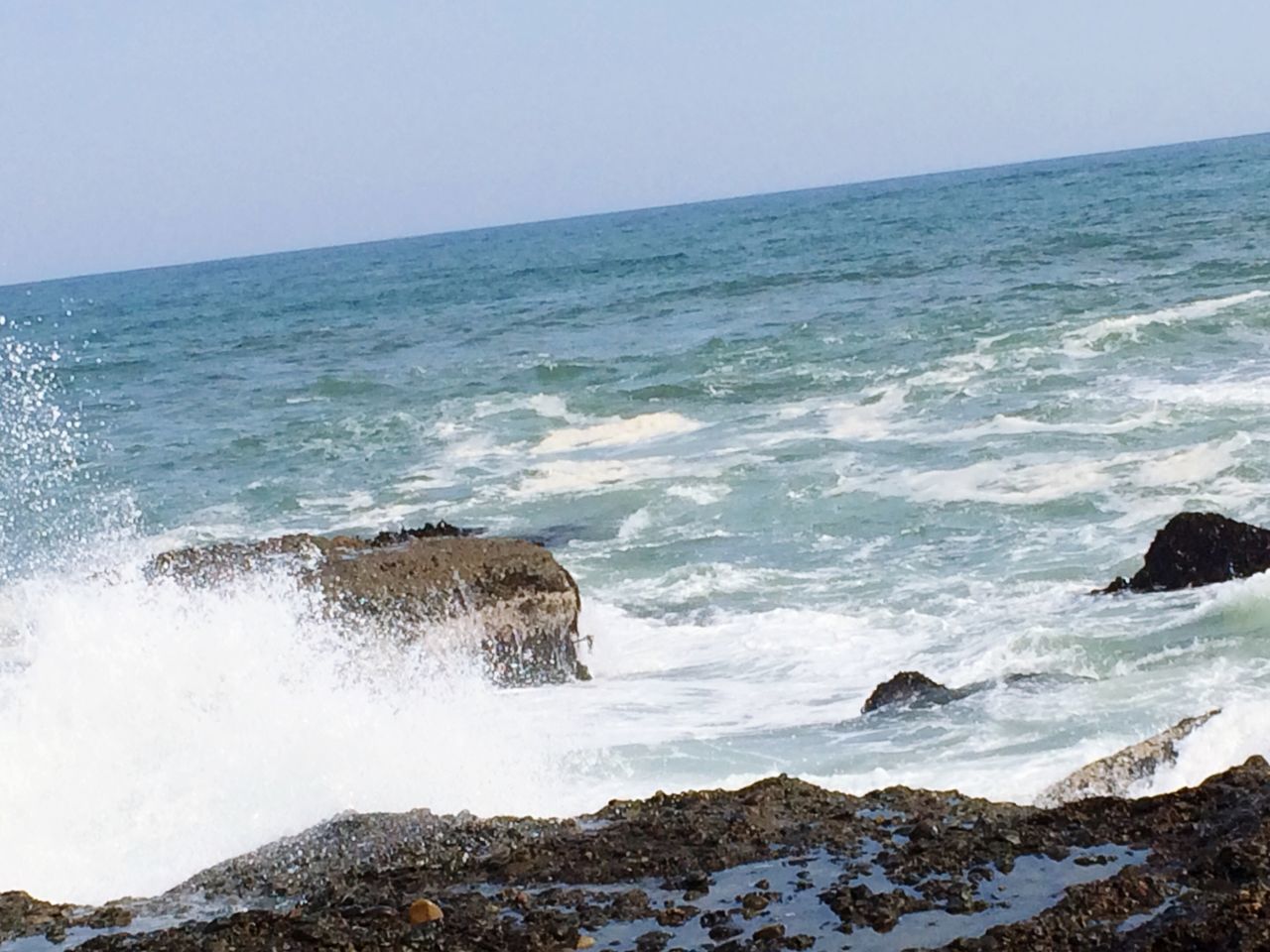 sea, water, horizon over water, surf, wave, scenics, clear sky, beauty in nature, beach, nature, shore, rock - object, tranquil scene, motion, tranquility, rock formation, coastline, copy space, idyllic, day