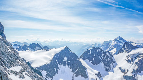 Scenic view of snow covered mountains against sky