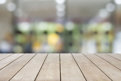 Close-up of wooden bench on boardwalk