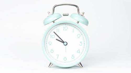 Close-up of clock on white background