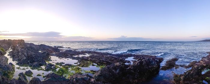 Scenic view of sea against clear sky at sunset