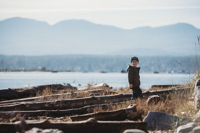 Portrait of man standing on mountain against sky