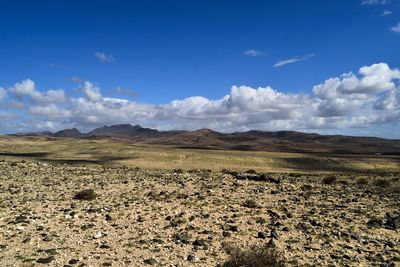 Scenic view of arid landscape against sky