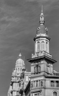 Low angle view of clock tower amidst buildings in city