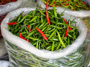 Bags with green and red chili peppers on a food market in bangkok, thailand.