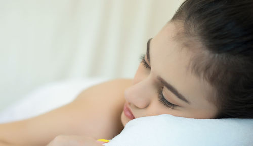 Young woman lying on massage table in spa