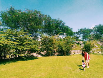 Full length of man standing on grassy field in park