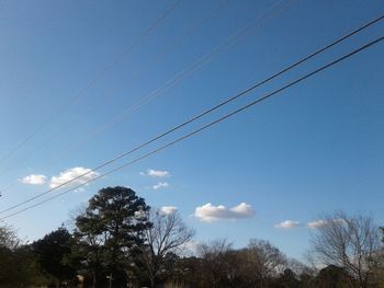 Low angle view of electricity pylon against sky