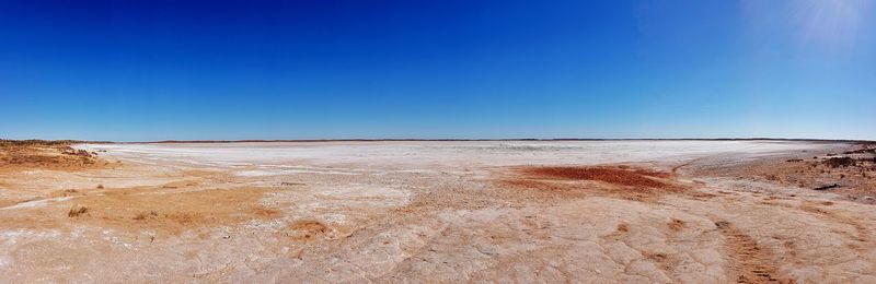 Scenic view of land against clear blue sky