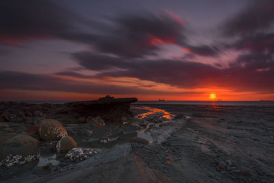 Scenic view of sea against orange sky