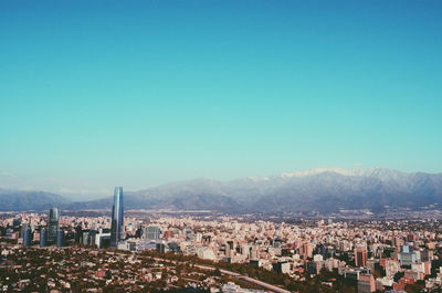 Gran torre santiago amidst cityscape against clear sky