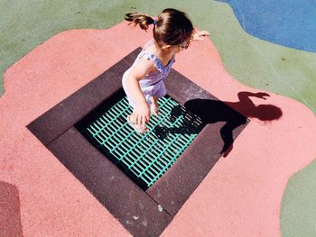 High angle view of little girl jumping