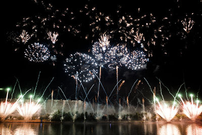 Low angle view of firework display at night